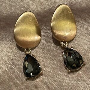 Large brass waves host elegant drops of faux Gemstone.Length 1 1/2”